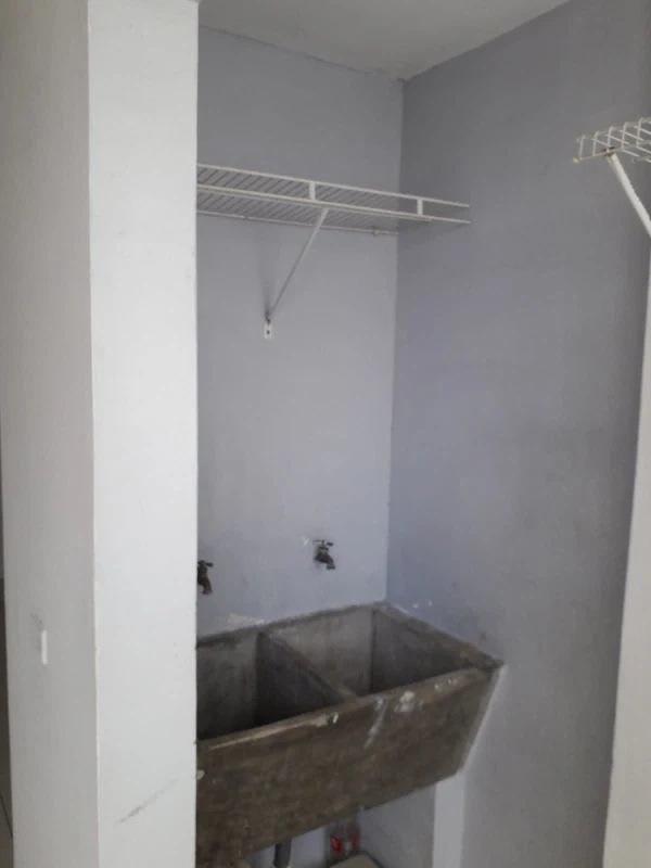 Laundry area with utility sink window and tiled walls PH Mystic Hills Panama