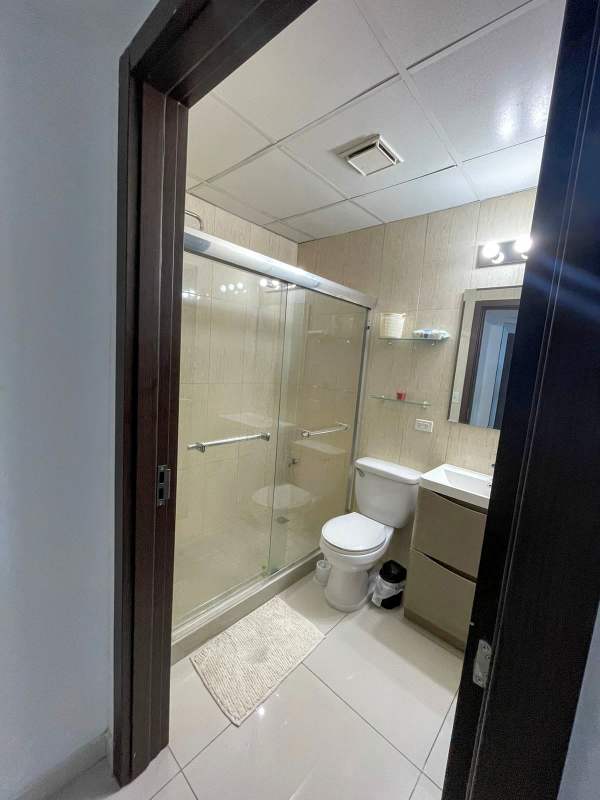 Contemporary shared bathroom with glass shower, vanity and tile in Costa del Este apartment