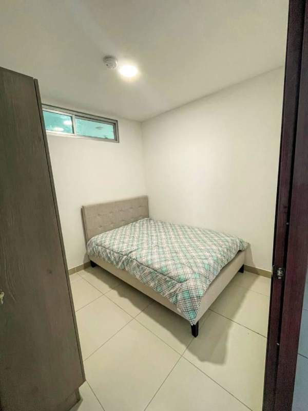 Living room with sofa, dining table, tiled floor and large window Panama City apartment