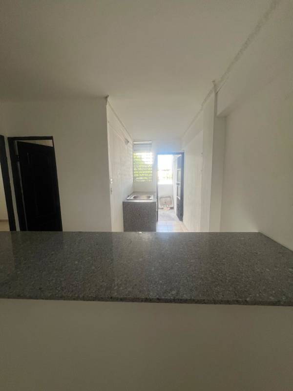 Kitchen with granite counters and door to laundry patio in Panama apartment