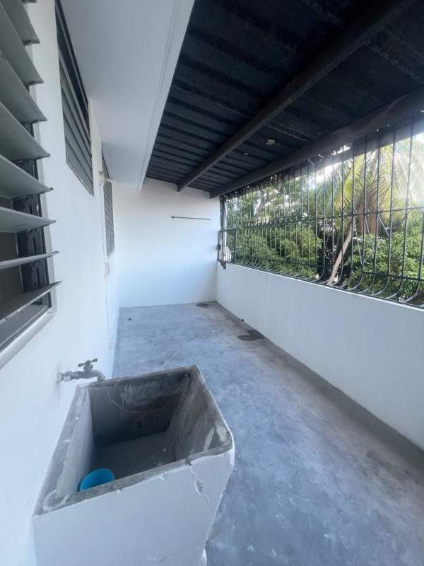 Outdoor laundry area with wash basin and metal security bars in Rio Abajo Panama