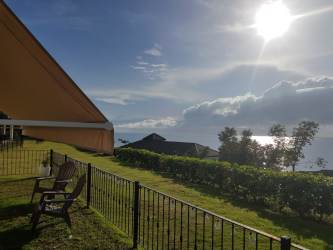 Aerial view of illuminated infinity pool, gardens, and moonlit ocean at Ensenada Beach Resort San Carlos Panama