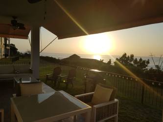 Modern apartment complex with beachfront pool, lounge chairs, and tropical landscaping at Ensenada Resort Panama