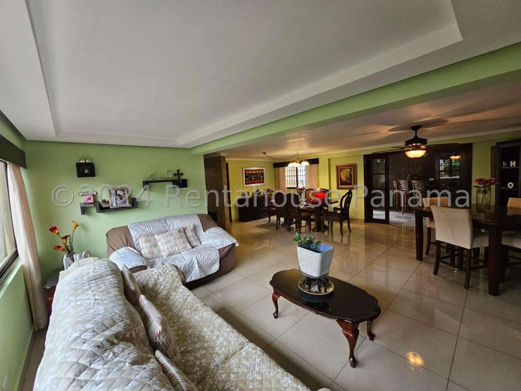 Bedroom with green accent wall, ceiling fan, tile floors built-in wardrobe Altos del Golf Panama