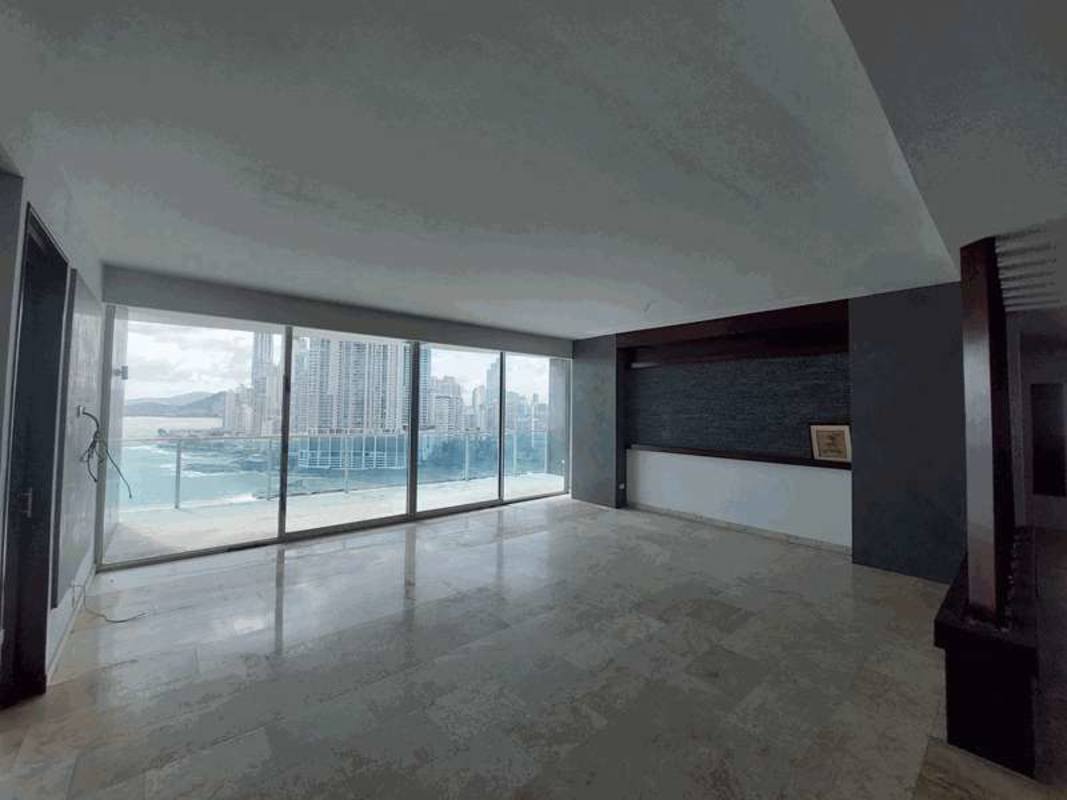 Bright living area with floor-to-ceiling windows showcasing ocean and skyline views in PH AquaMare Punta Pacifica Panama