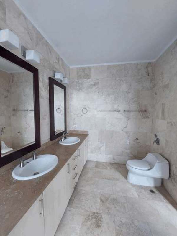 Modern bathroom with double sink vanities, large mirrors, beige tiles in PH AquaMare Punta Pacifica