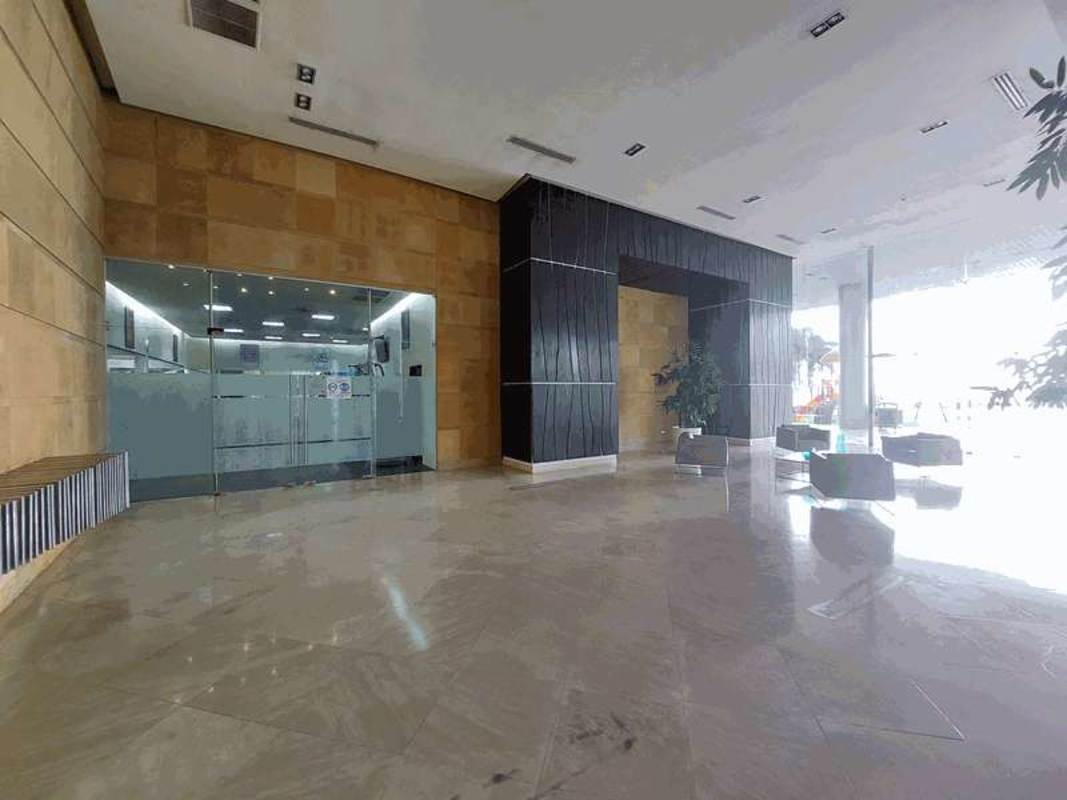 Sophisticated marble lobby entrance with wood paneling and glass doors at PH AquaMare Punta Pacifica Panama City