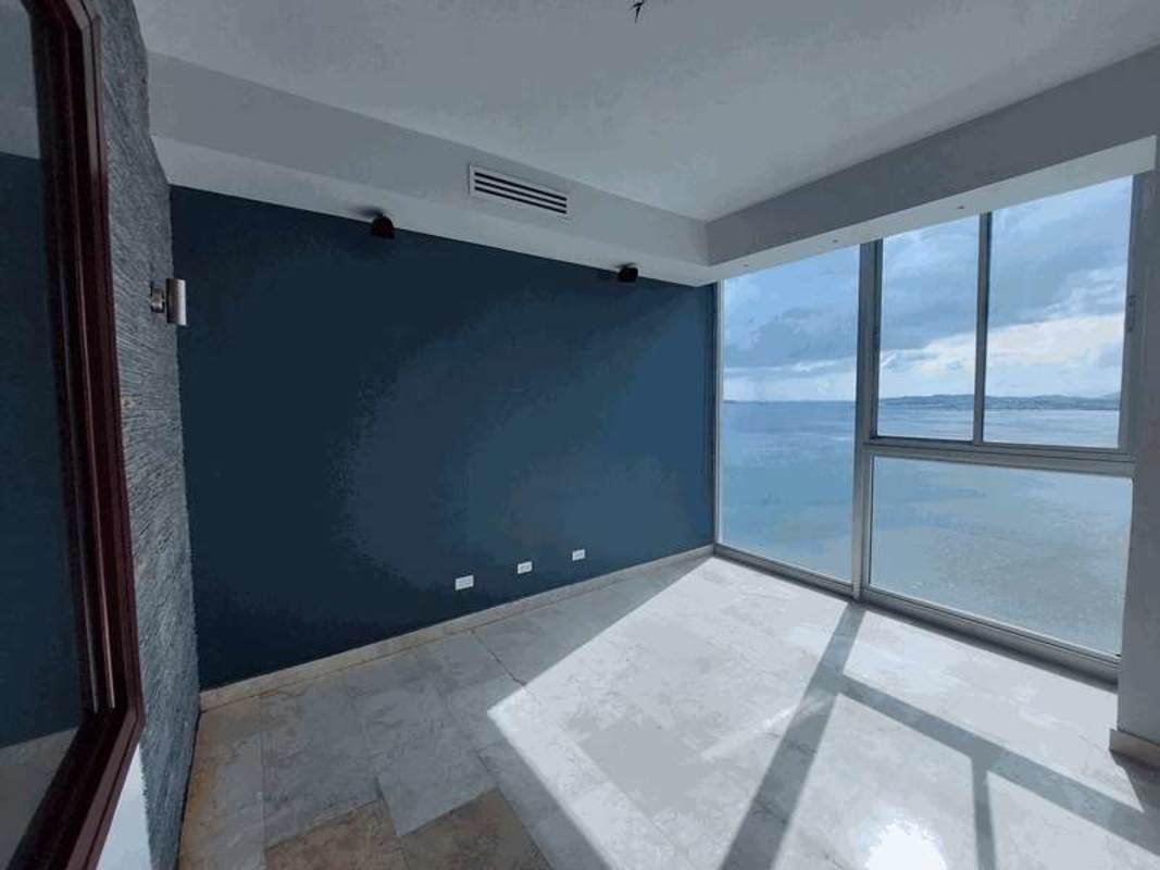 Bedroom featuring floor-to-ceiling windows with ocean panorama in PH AquaMare Punta Pacifica Panama City