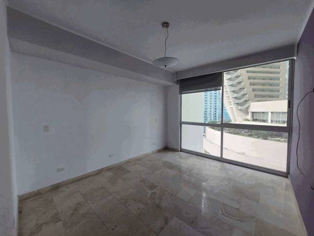 Bright open-concept living area with large windows showcasing city skyline and ocean in PH AquaMare Punta Pacifica