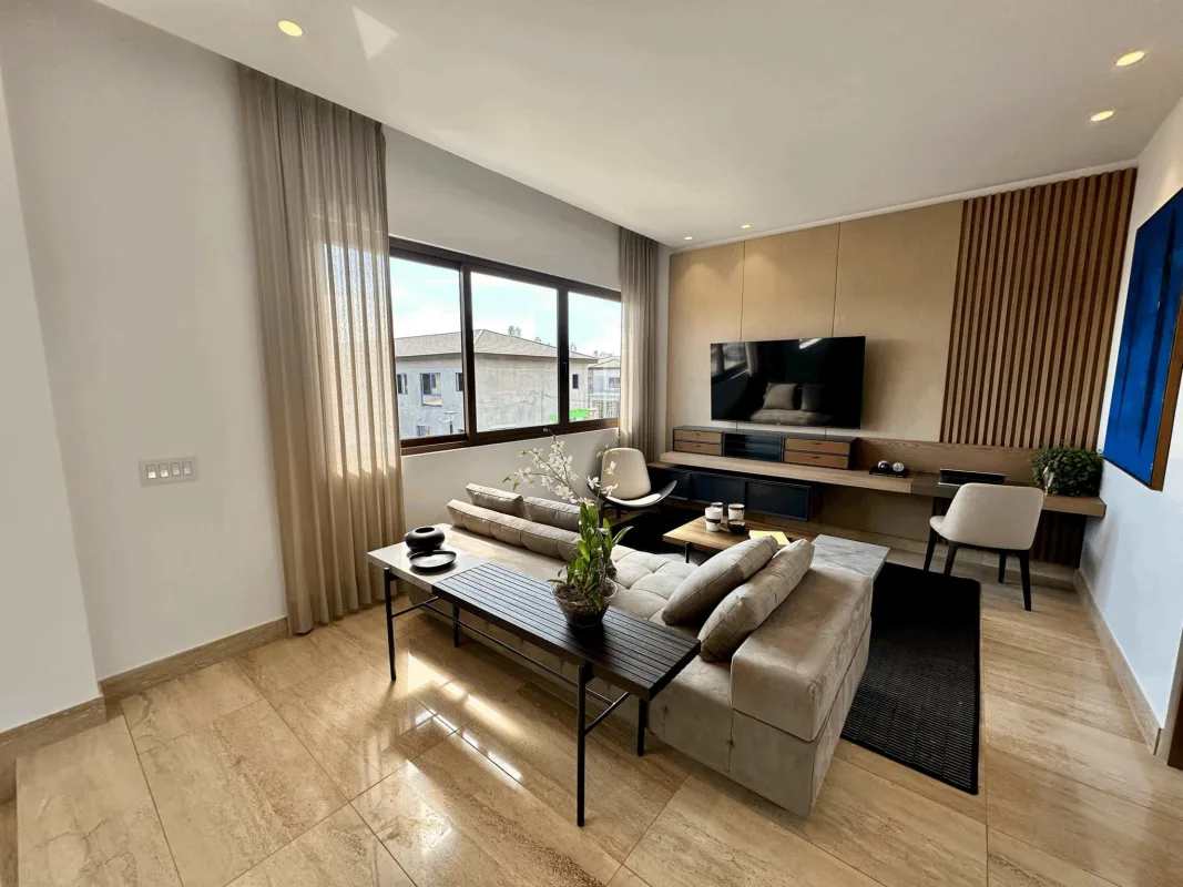 Spacious kitchen with marble countertops, island and wood cabinetry at The Woods Santa María Panama City