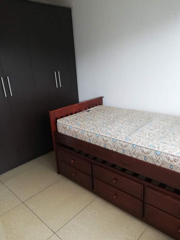 Minimalist bedroom with storage drawers bed and large wardrobe PH Urbis Panama