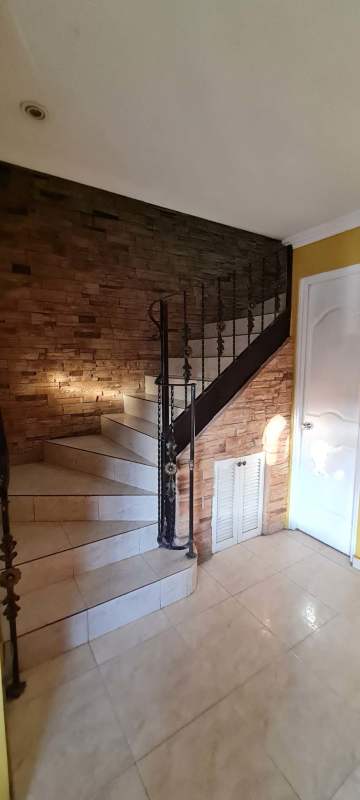 Curved staircase with stone wall feature rental house Brisas del Golf Panama