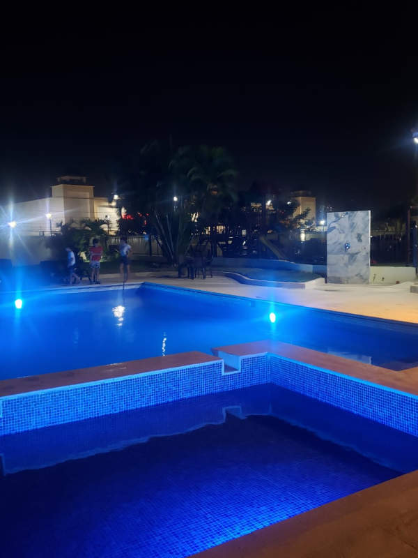 Illuminated swimming pool and jacuzzi area at night PH McGregor Valley