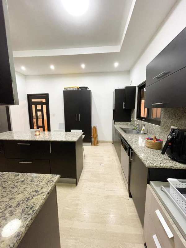 Screened covered patio with ceiling fans tile floor garden in Sunset Coast Panama