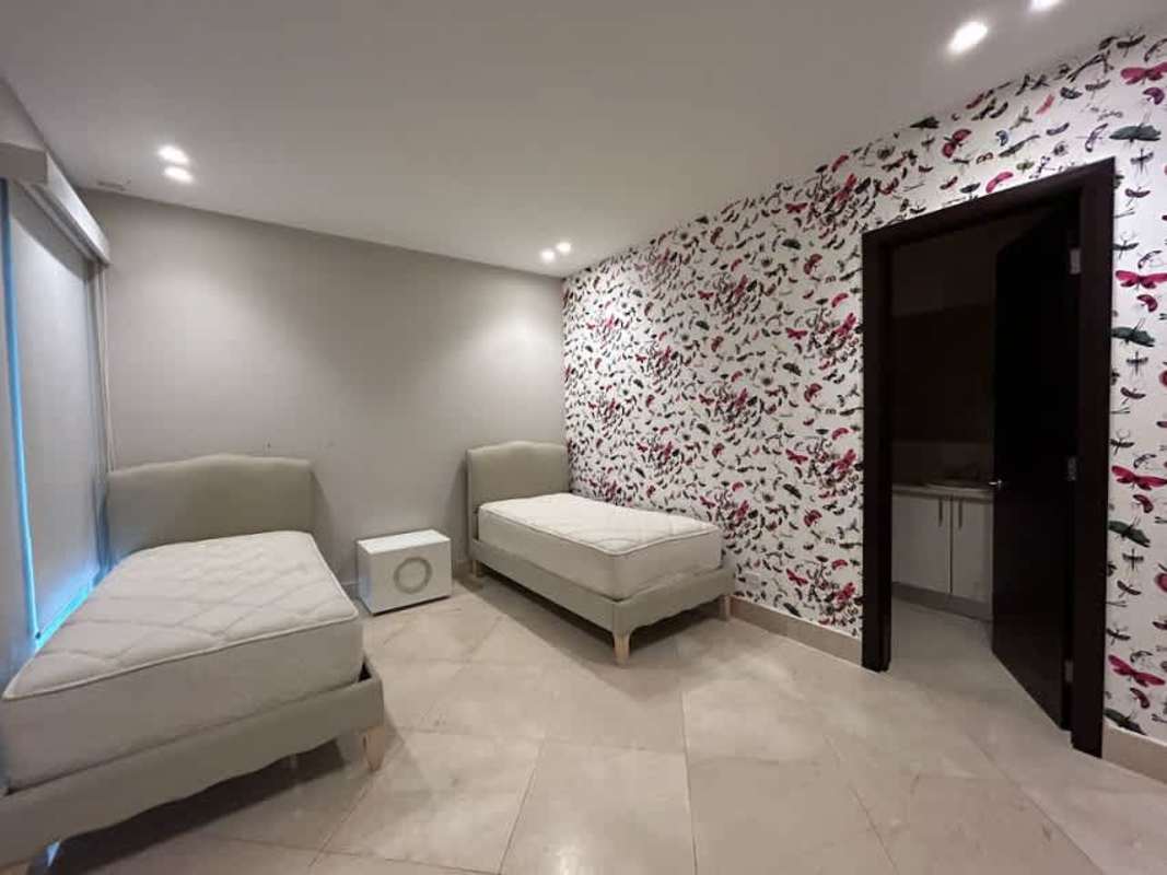 Large master bedroom with marble floors, floor-to-ceiling windows and ocean view at PH Miradores Punta Paitilla