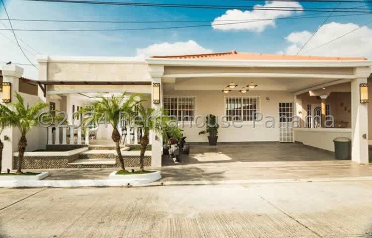 Suburban home with carport, front porch, tropical plants in Brisas del Golf II Panama City