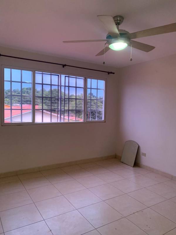 Spacious bedroom with large window ceiling fan tile floor Villa Zaita Panama