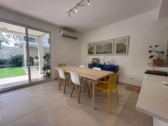 Contemporary kitchen with peninsula, ceramic tiles, and appliances in Panama Pacifico townhouse