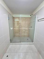 Bathroom with walk-in shower glass enclosure tiled walls PH Midrise Panama Pacifico