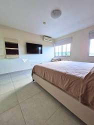 Modern bedroom with TV wall mount, large windows, tiled floor Panama Pacifico