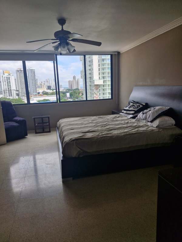 Wide living room with large windows and city skyline view in PH Marsella Marbella Panama