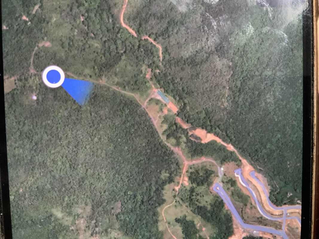 Aerial photo showing dense forest land, dirt roads, and location near Green City Panama