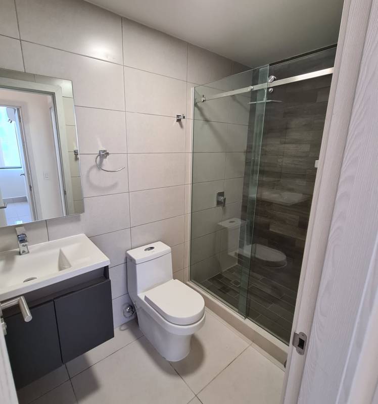 Equipped gym facility with cardio, weights and city skyline view at Coco Place Panama