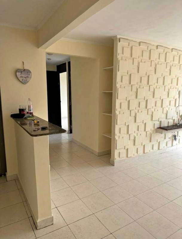 Minimalist living dining area with accent wall and kitchen bar in Villa Zaita apartment for sale Panama