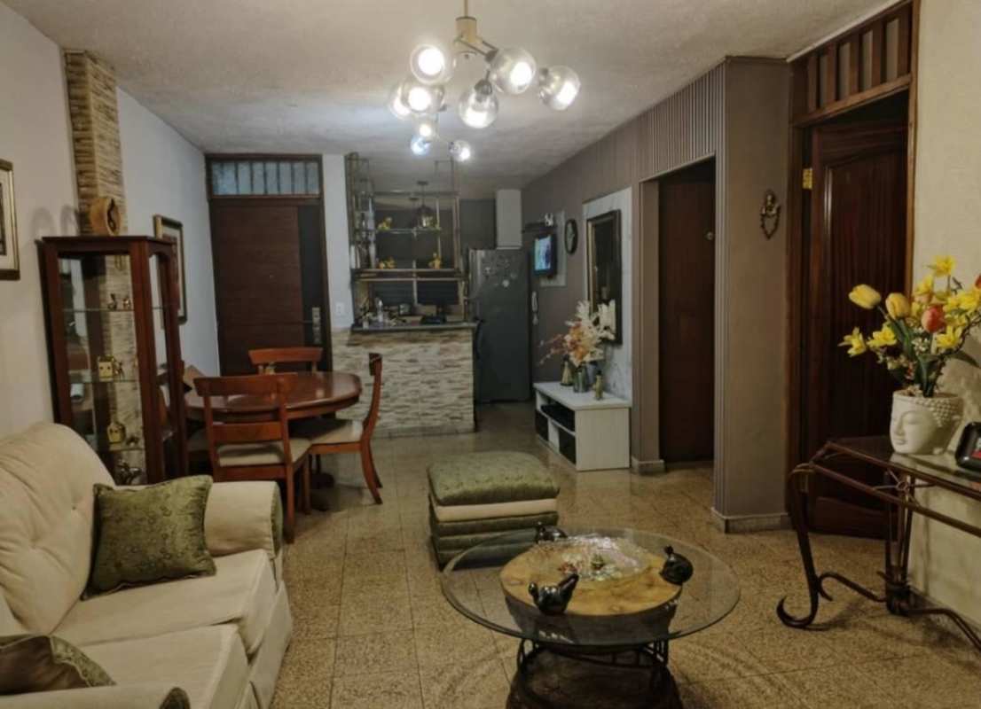 Private balcony with plants, AC, white chair and urban view in Carrasquilla Panama