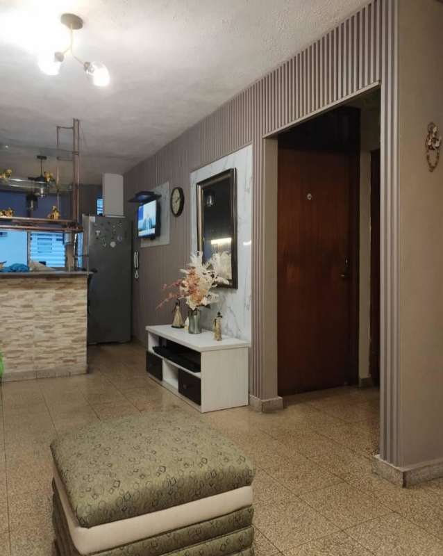 Shared living area with kitchen, striped wall and modern decor Carrasquilla Panama