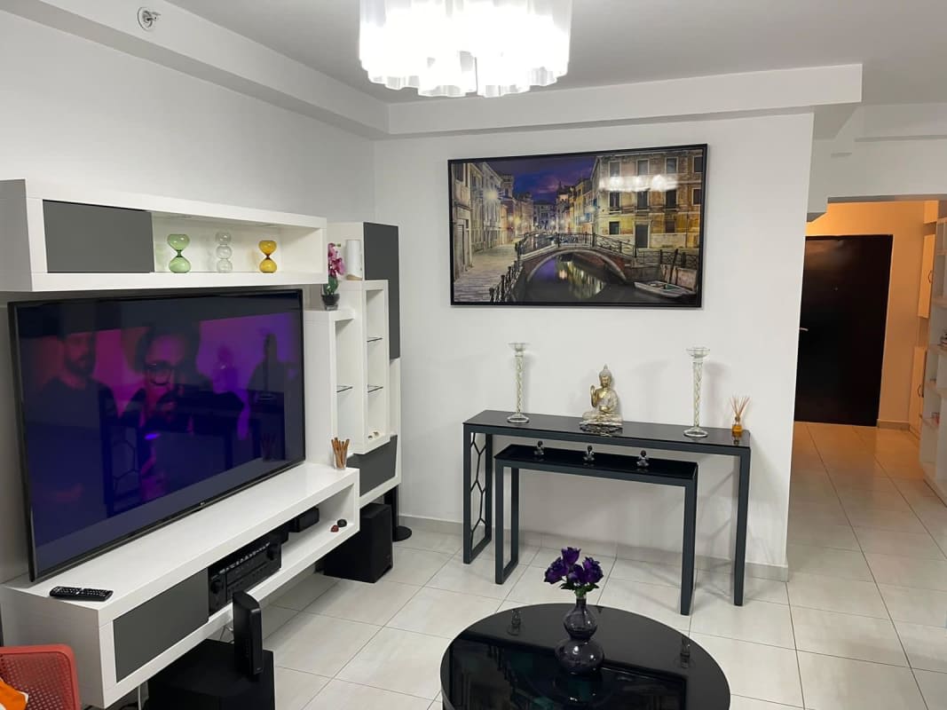 Living room with modern entertainment wall, blue sofa PH Trinity Tower El Carmen Panama