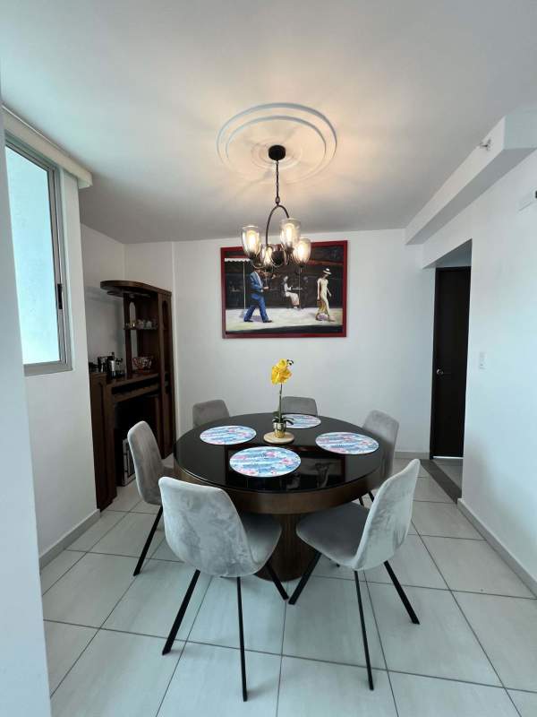 Contemporary dining room with seating for six and modern chandelier Trinity Tower Panama