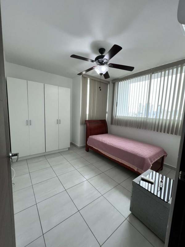 Minimalist bedroom with white wardrobe, natural light PH Trinity Tower Panama 