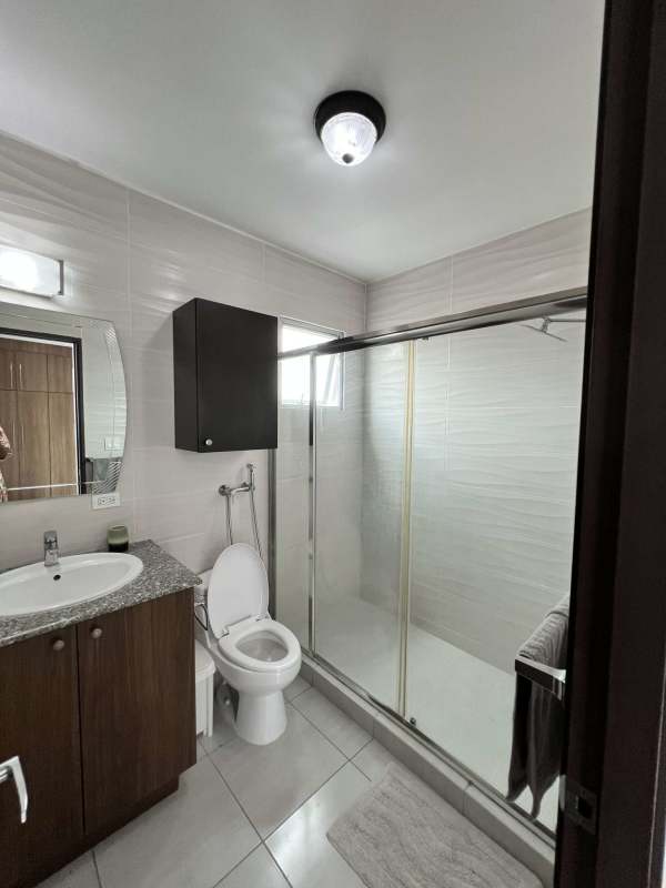 Minimalist bathroom with walk-in shower pedestal sink Trinity Tower El Carmen Panama