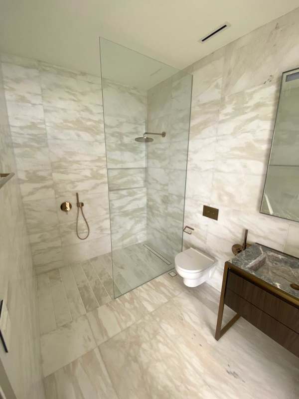 Luxury living room with marble floors, floor-to-ceiling windows, panoramic Costa del Este and ocean views