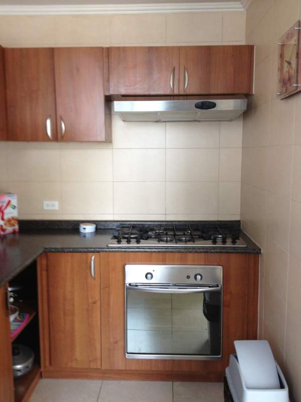 Kitchen with granite countertop, wood cabinets, gas stove in PH Onyx Via Argentina Panama