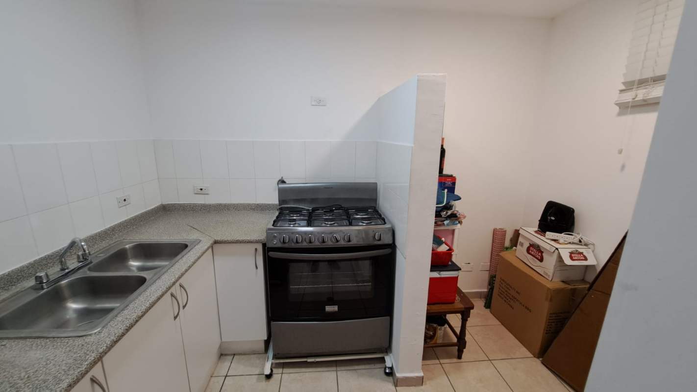 Compact kitchen with granite counters, gas stove, double sink in PH La Loma Residences Panama