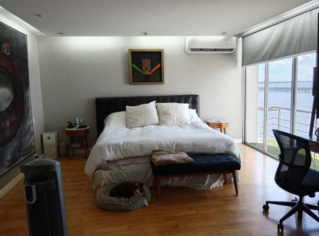 Spacious master bedroom with large windows overlooking Pacific Ocean PH Las Llamas