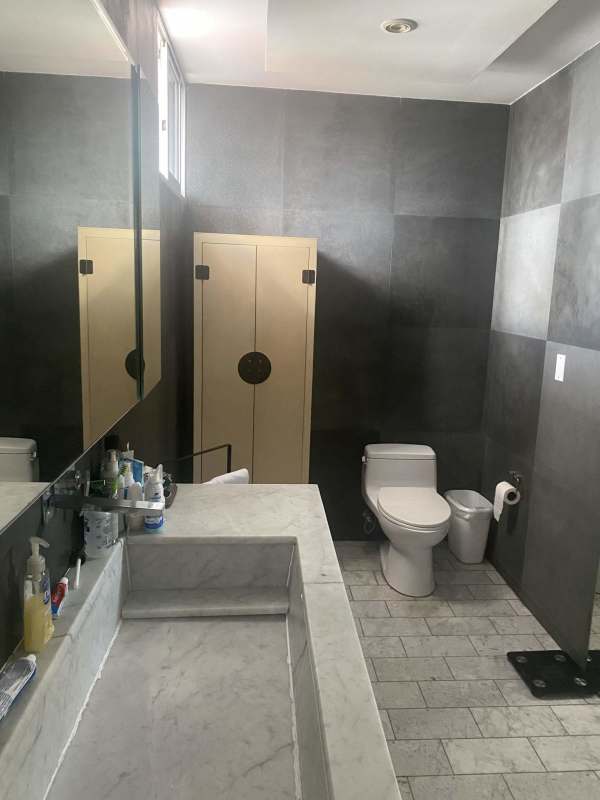 Remodeled bathroom with marble countertop, spacious mirror PH Las Llamas