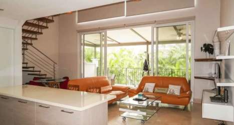 Modern living area with balcony views and contemporary furniture Puntarena Loft Buenaventura Panama