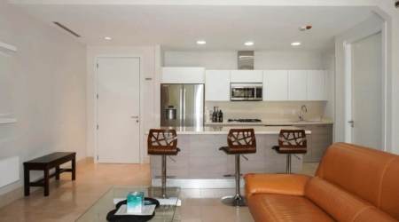 Modern open-plan kitchen and living area with granite counters and contemporary decor in Puntarena Loft Buenaventura Panama