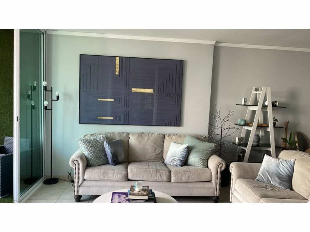 Elegant living room with beige sofas, minimalist decor, sliding glass doors to balcony in PH Costa Pacifica Punta Pacifica Panama