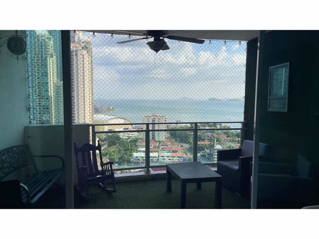 Balcony with outdoor furniture, glass railing, panoramic sea and city views in PH Costa Pacifica Panama