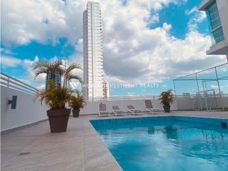 Panoramic rooftop pool area with lounge chairs and skyline view Punta Pacifica Panama