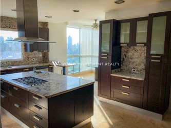 Modern kitchen with granite countertops, island cooktop, large windows city view PH Punta Arenas Punta Pacifica