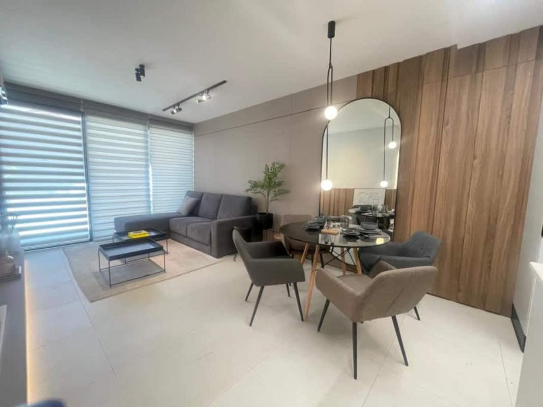 Bedroom with panel headboard, floating nightstands, modern lighting in PH Coco del Mar Panama