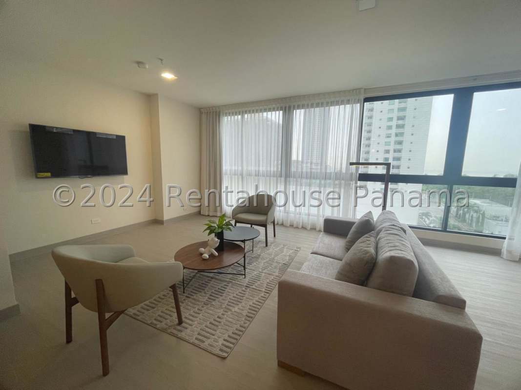 Living room with floor-to-ceiling windows, grey sofa, TV in PH Arcadia Costa del Este Panama City