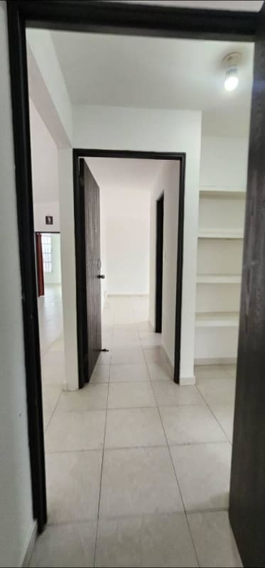 Hallway with ceramic floor and built-in shelves in 4-bedroom rental house Brisas del Golf Panama