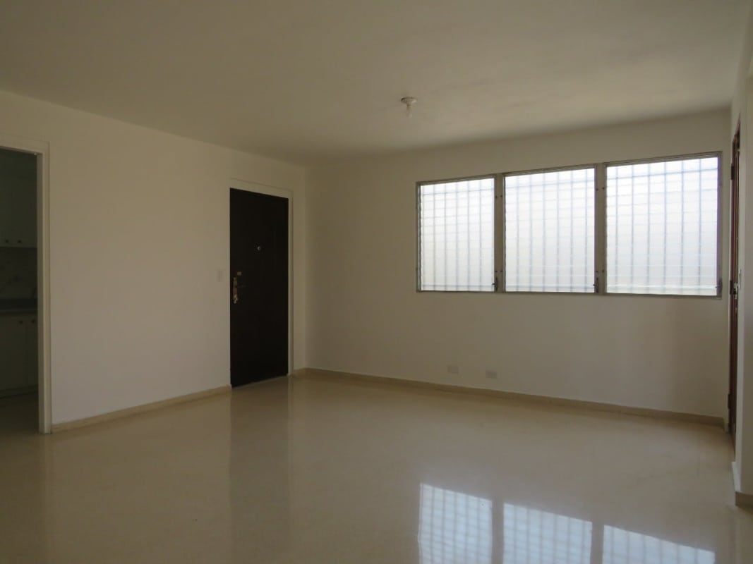 Bright minimalist kitchen with marble backsplash white cabinets and double sinks in Residencial La Loma Panama City
