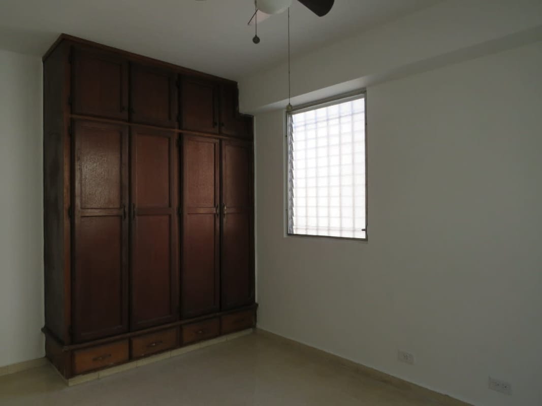 Bright bedroom with security window and tile floor in Residencial La Loma Panama